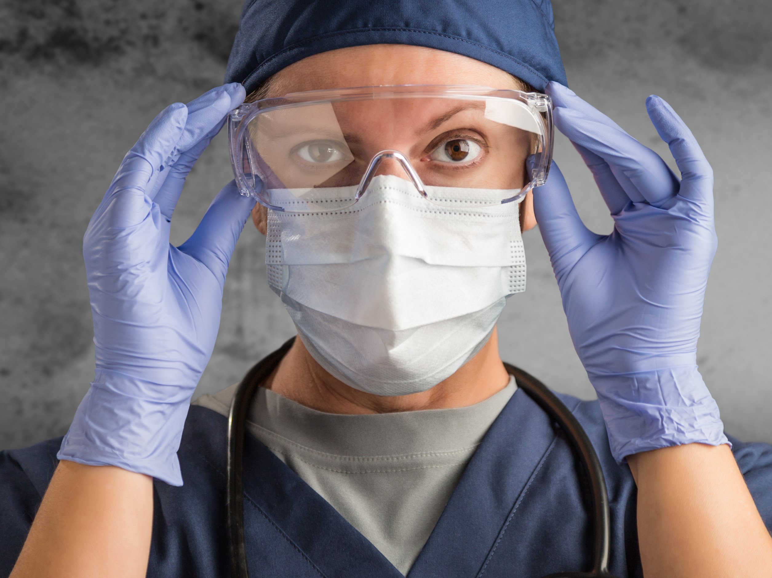 Healthcare worker putting on PPE