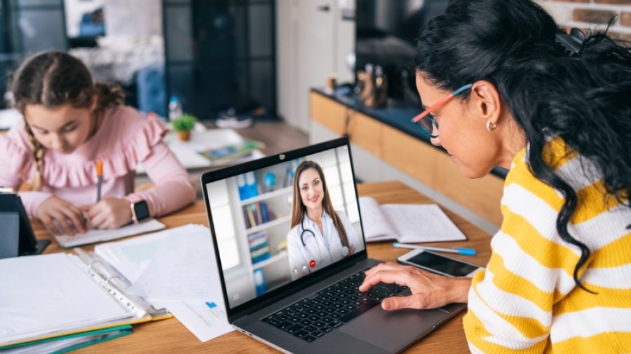 Mother speaking to doctor via Telehealth