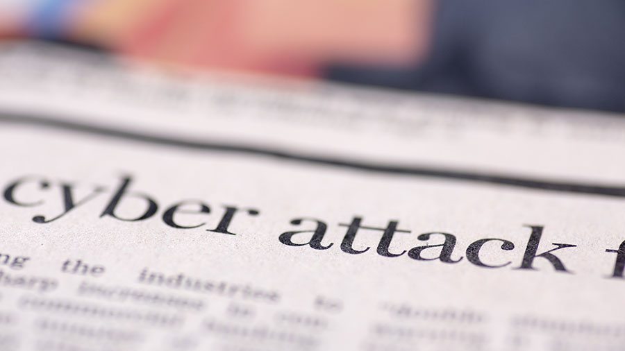 newspaper headline "cyber attack"