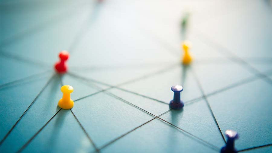 Thumbtacks and strings creating a map