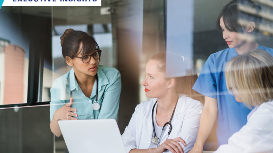 Healthcare workers reviewing executive insights