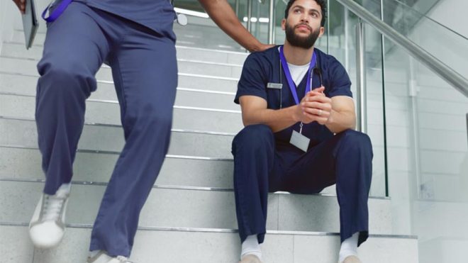 Physician sitting on steps