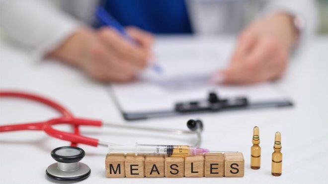 Doctor, stethoscope and measles blocks 