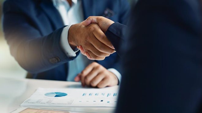 Handshake over paperwork