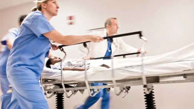 Doctors pushing gurney