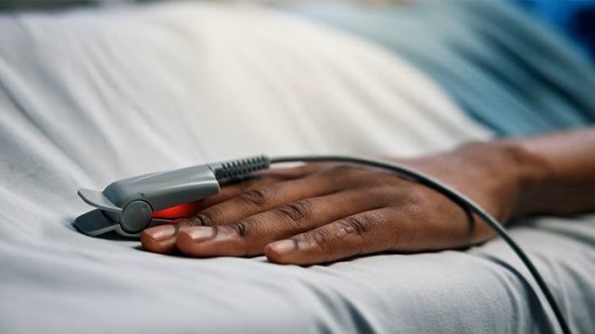 Patient's hand on a bed
