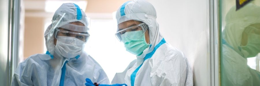 Two doctors reading notes and holding a sample