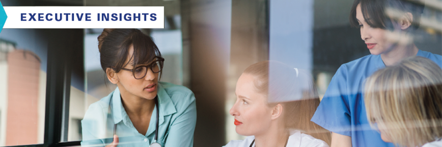 Healthcare workers reviewing executive insights