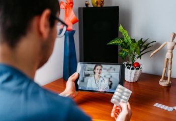 Practicing physician having online meeting with a patient
