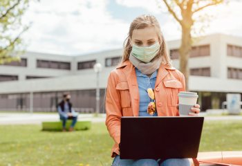 Woman on Laptop with Mask