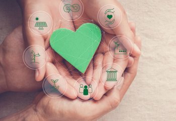 Hands holding green heart