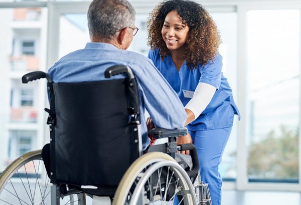 Nurse helping elderly patient in a wheelchair