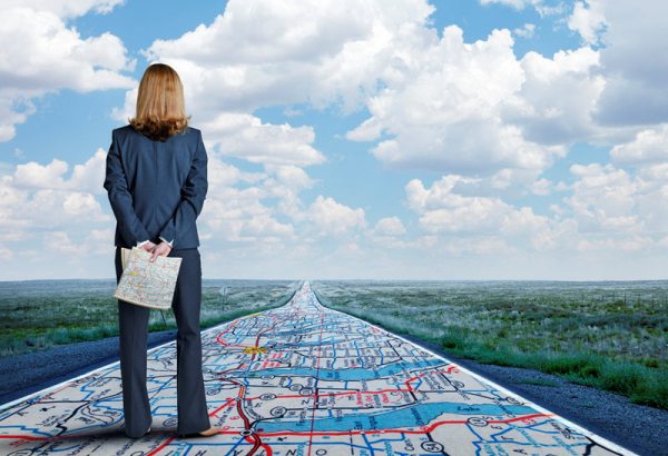 Woman standing on mapped road