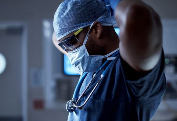 Healthcare worker putting on medical mask