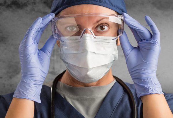 Healthcare worker putting on PPE
